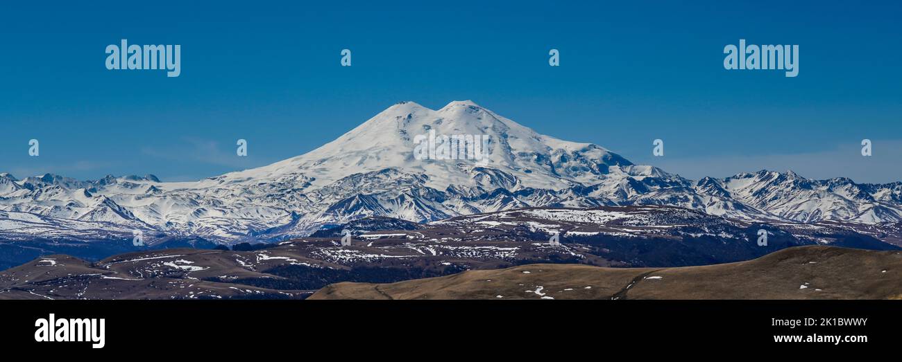 Panorama of Mount Elbrus against the backdrop of the Main Caucasian Range. Karachay-Cherkessia. Russia. Stock Photo