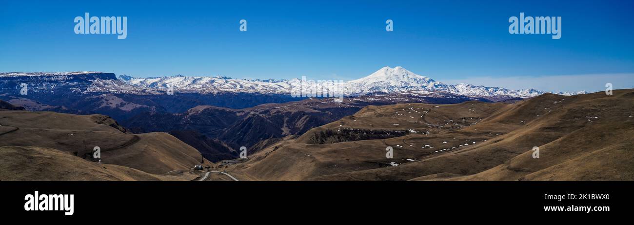 Panorama of Mount Elbrus against the backdrop of the Main Caucasian Range. Karachay-Cherkessia. Russia. Stock Photo