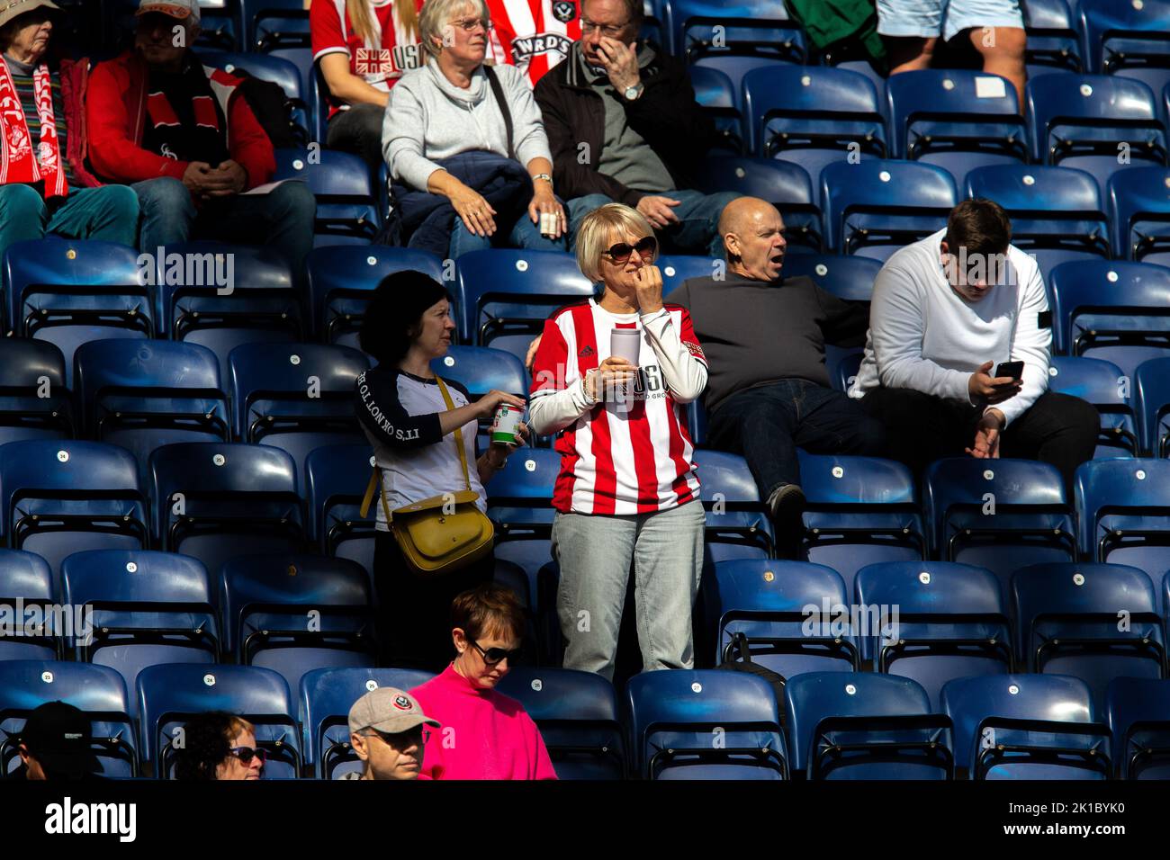 A Sheffield United fan chews her nails during the Sky Bet Championship match Preston North End vs Sheffield United at Deepdale, Preston, United Kingdom, 17th September 2022  (Photo by Phil Bryan/News Images) Stock Photo