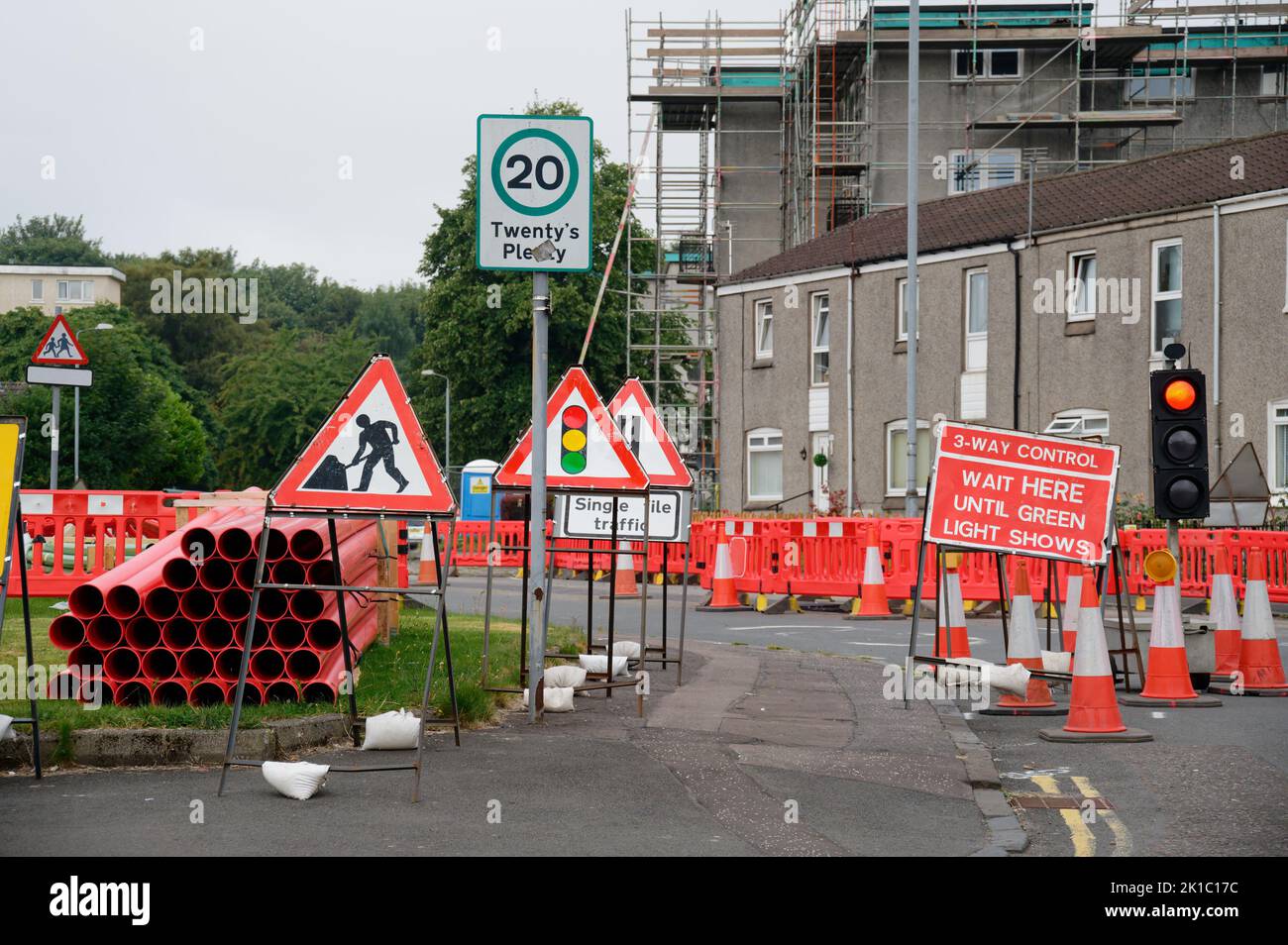 Traffic control signs and lights at road works Stock Photo