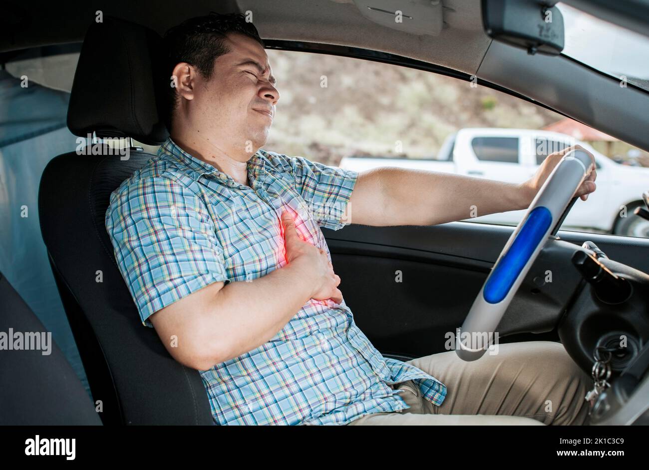 Suffering driver with chest pain. Male driver with chest pain in ...