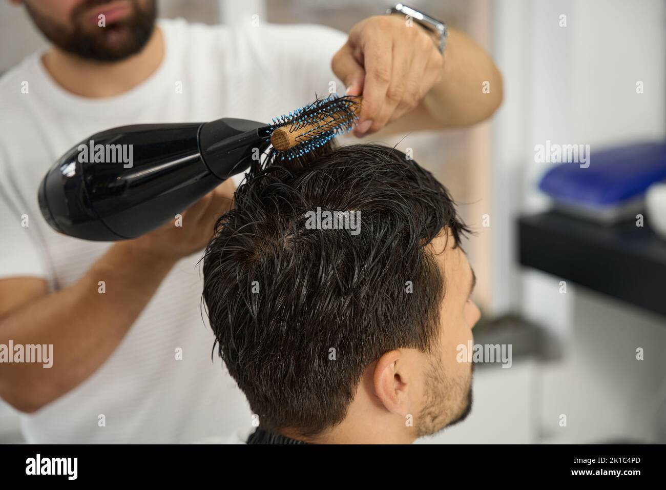 Barber blow drying man hi-res stock photography and images - Alamy