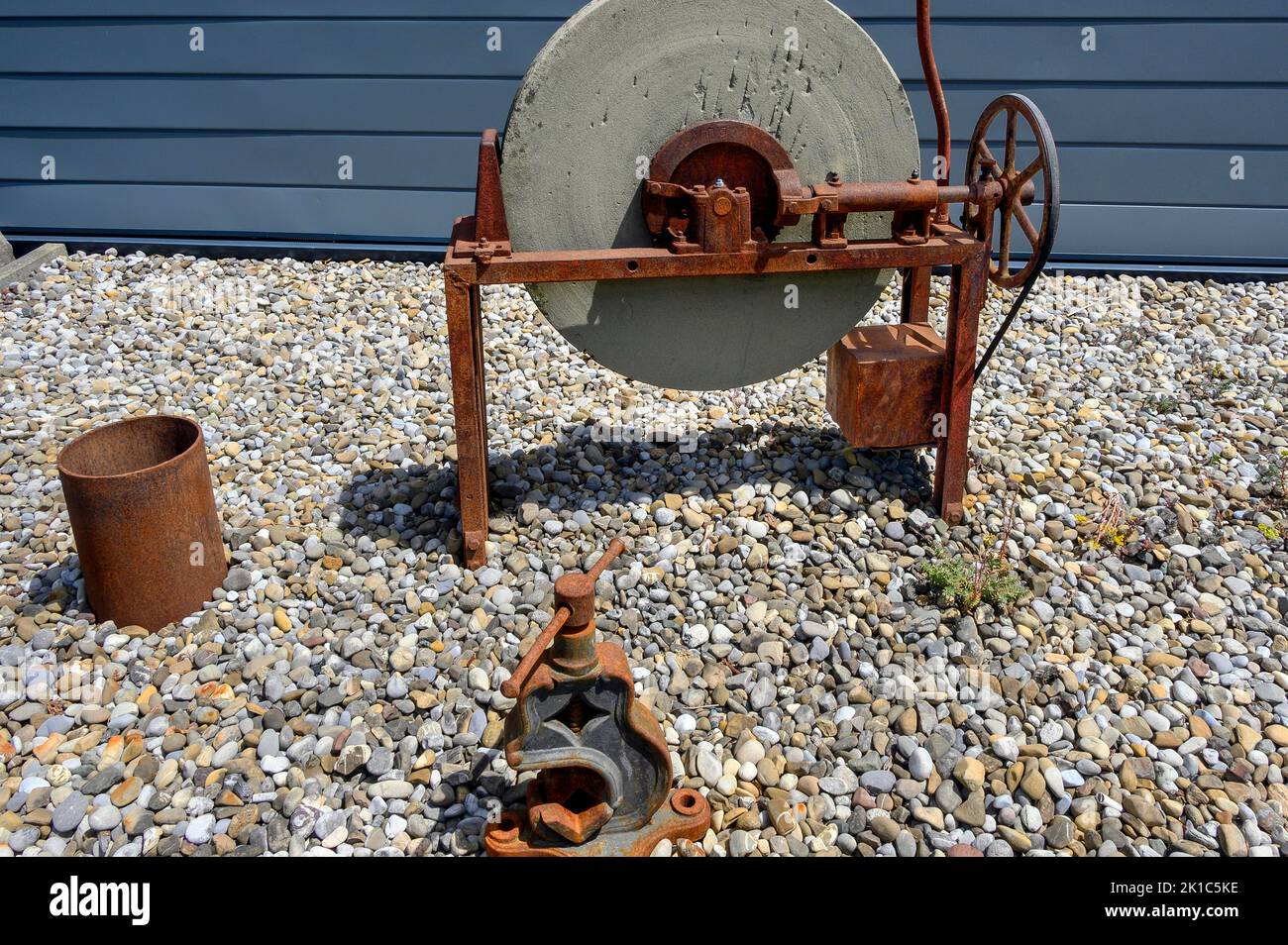 Old grindstone with rusted mechanics, Buchenberg, Bavaria, Germany Stock Photo
