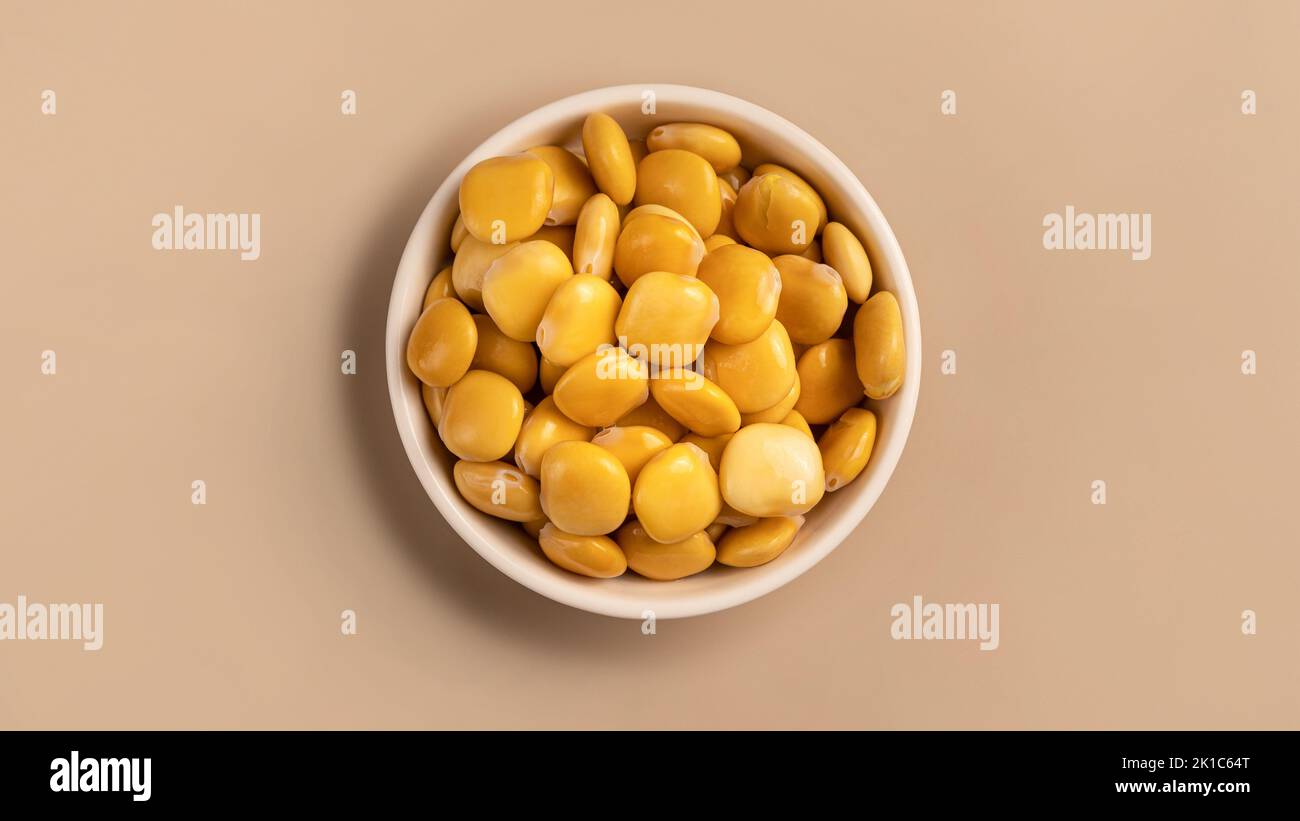 salted Lupin Beans in white bowl Stock Photo