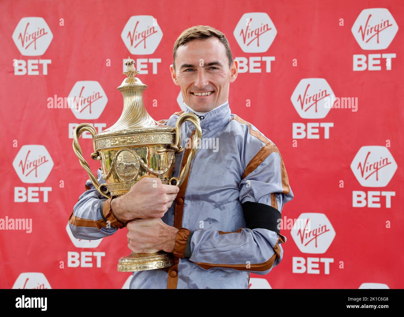 Jockey Daniel Tudhope with the trophy after winning the Virgin Bet Ayr Gold Cup Handicap on Summerghand during the Virgin Bet Ayr Gold Cup day at Ayr Racecourse, Ayr. Picture date: Saturday September 17, 2022. Stock Photo
