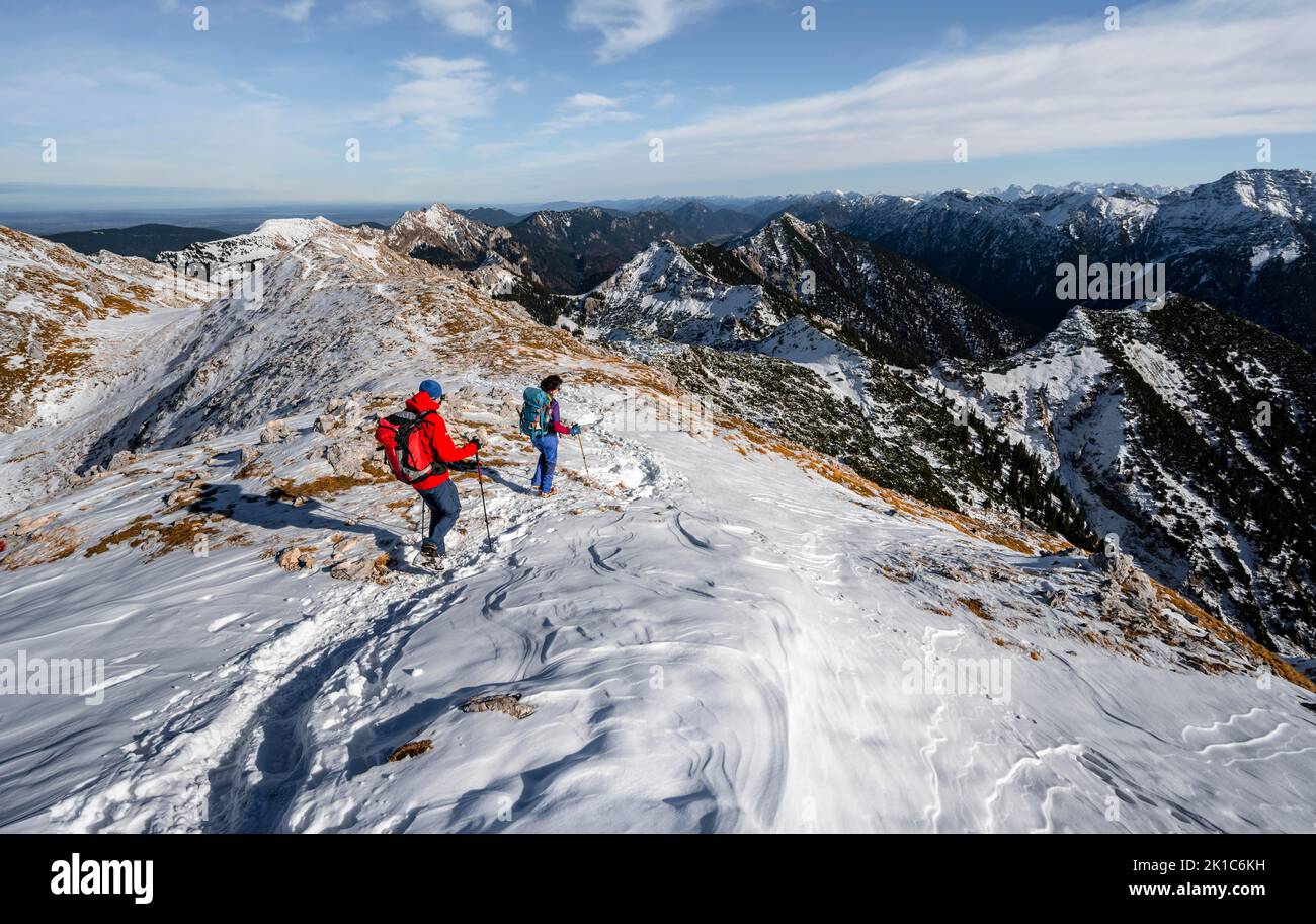 Two mountaineers on the rocky snowy ridge of the Ammergauer Hochplatte, view towards Loesertaljoch, view of mountain panorama, hiking to the Stock Photo