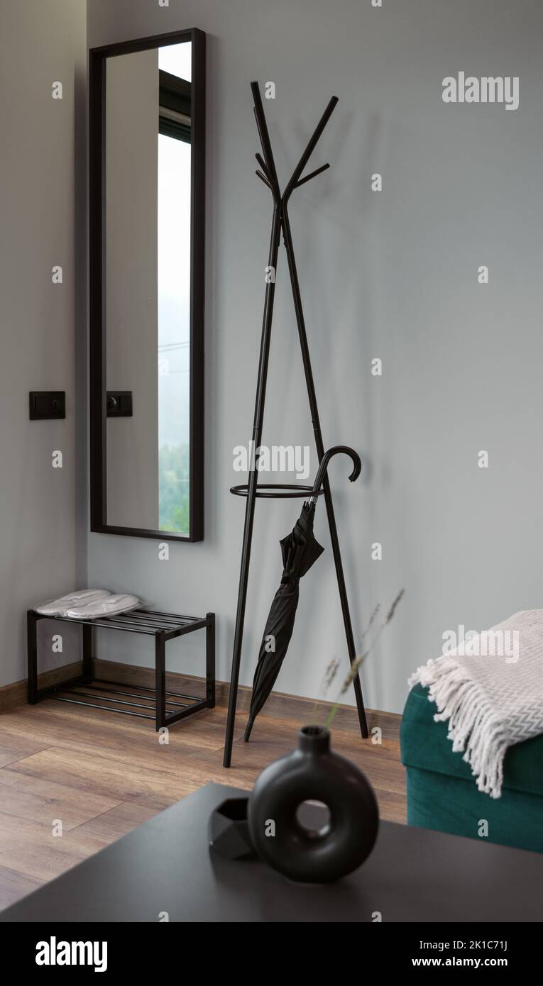 Modern clothes hanger stand and mirror in modern house Stock Photo
