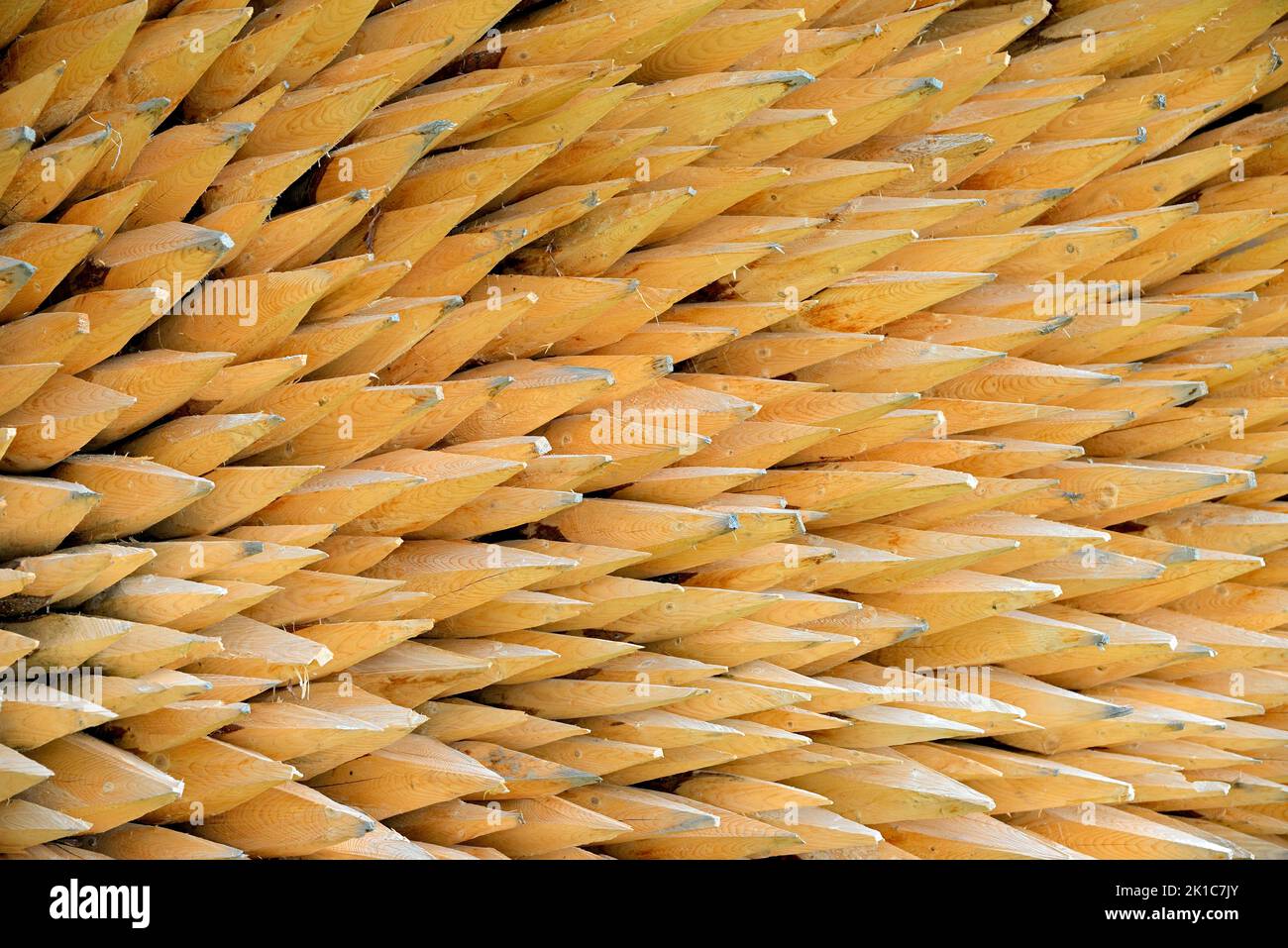 Stacked fence posts with sharpened ends, Bavaria, Germany Stock Photo