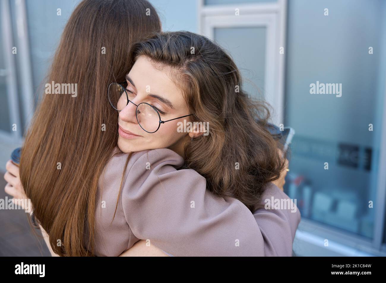 Two young people tightly hugged each other by the shoulders Stock Photo