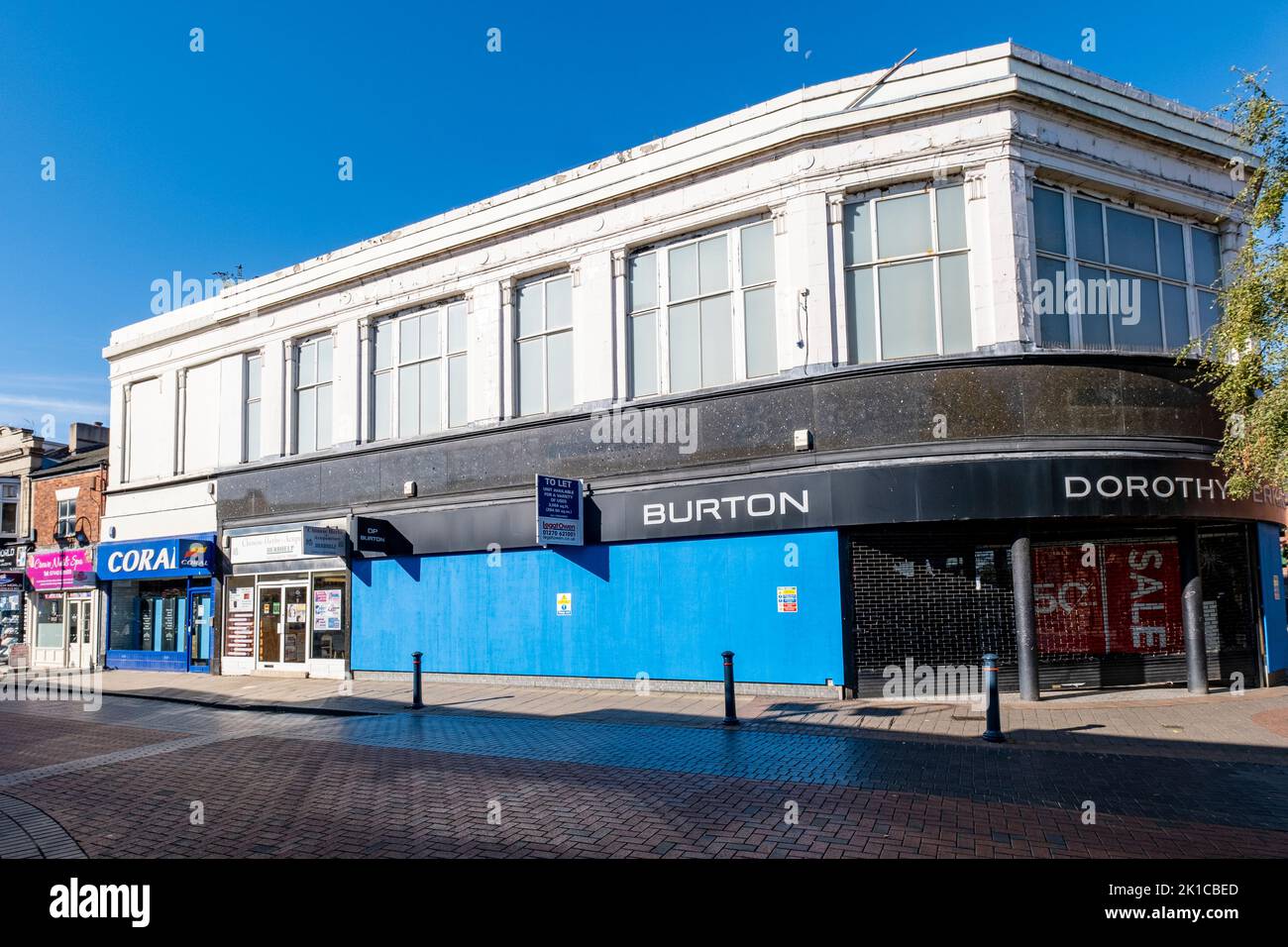 The closed down and boarded up Burton and Dorothy Perkins fashion shop in town centre of Crewe Cheshire UK Stock Photo