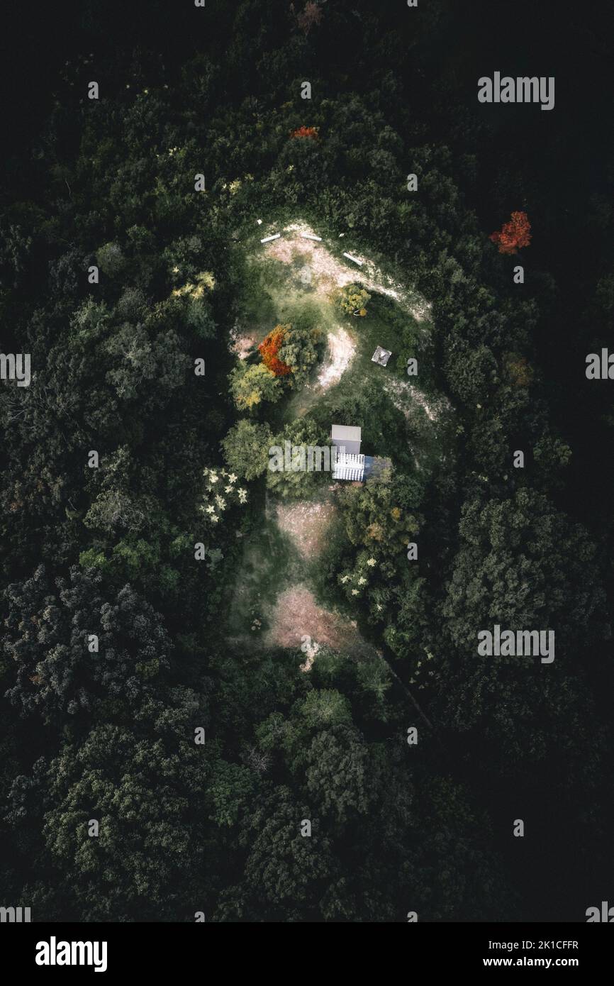An aerial of a house and a field surrounded by trees Stock Photo - Alamy