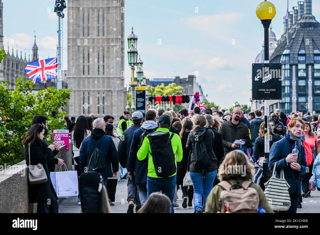 London, UK. 17th Sep, 2022. On westminster bridge and passing a Justice for Chris Kaba (who was shot by the Met Police) placard - The Queue to see the lying in state of the coffin of Queen Elizabeth II, which is in Westminster Hall. Credit: Guy Bell/Alamy Live News Stock Photo