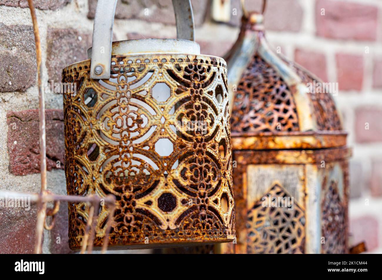 Rusted old lanterns on a rough brick wall Stock Photo