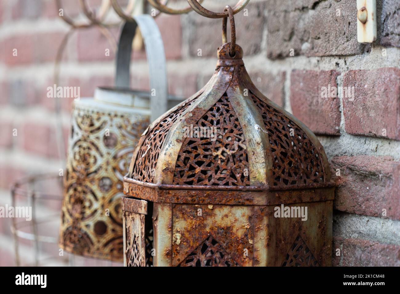Rusted old lanterns on a rough brick wall Stock Photo