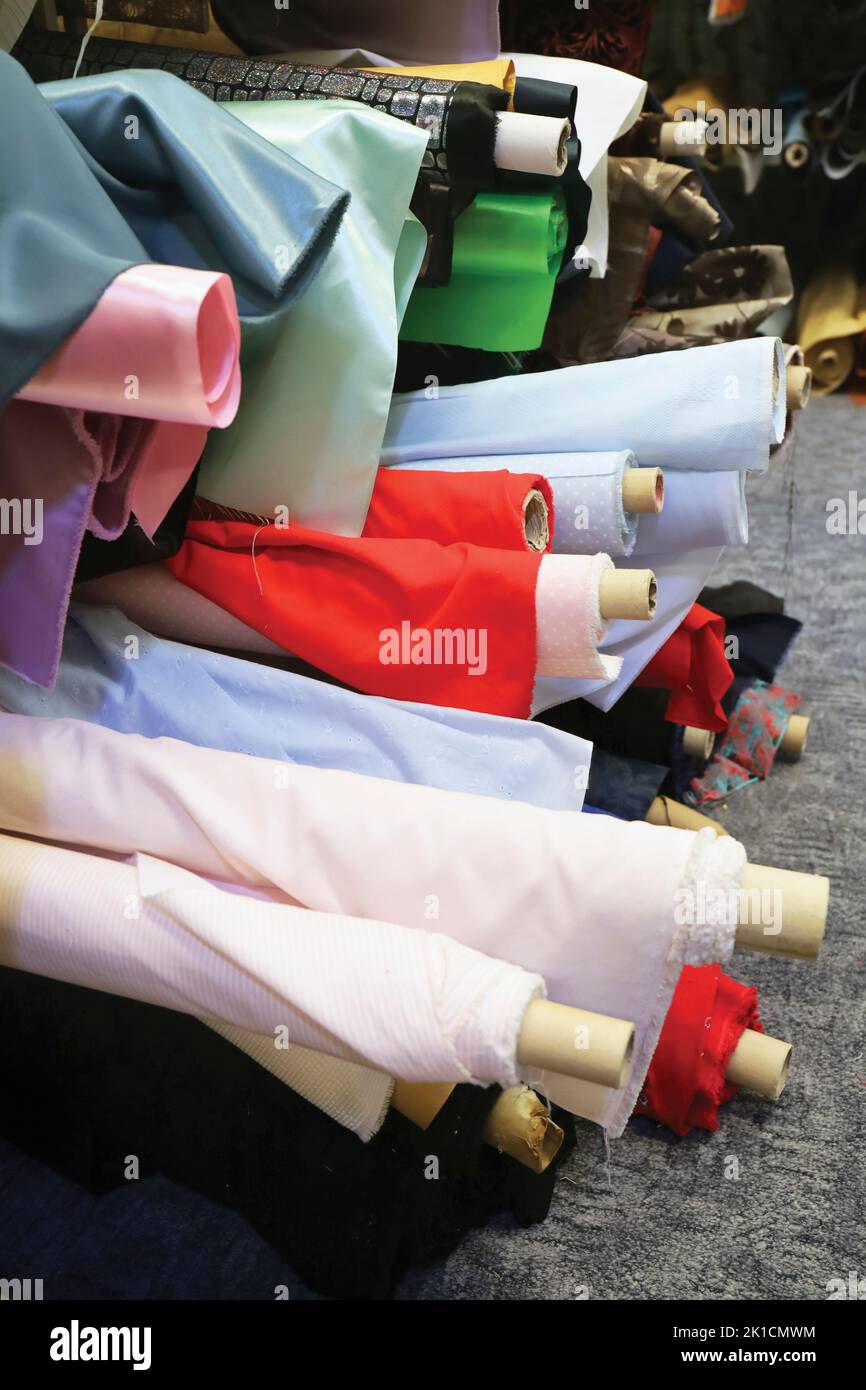 Rolls of material in a fabric shop. Stock Photo