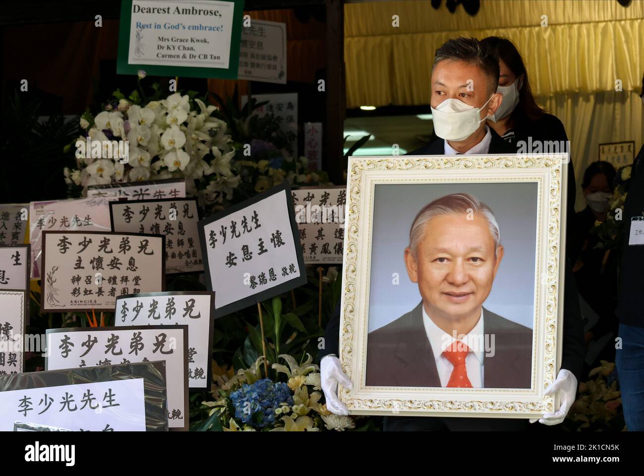 Glen Lee Lamyan holds his father Ambrose Lee Siukwong's portrait at