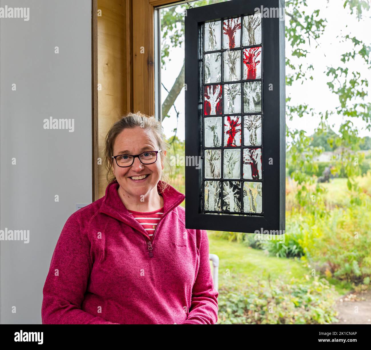 Amisfield Walled Garden, East Lothian, Scotland, UK, 17th September 2022. Art in the Garden: an exhibition of artwork by artists with differing styles and materials takes place for a week.  Pictured: stained glass maker Kate Henderson. Credit: Sally Anderson/Alamy Live News Stock Photo