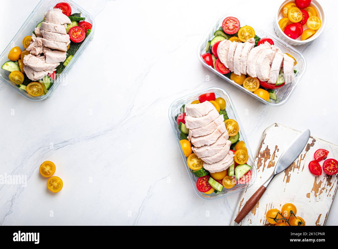 Meal prep lunch boxes containers with chicken and salad top view Stock