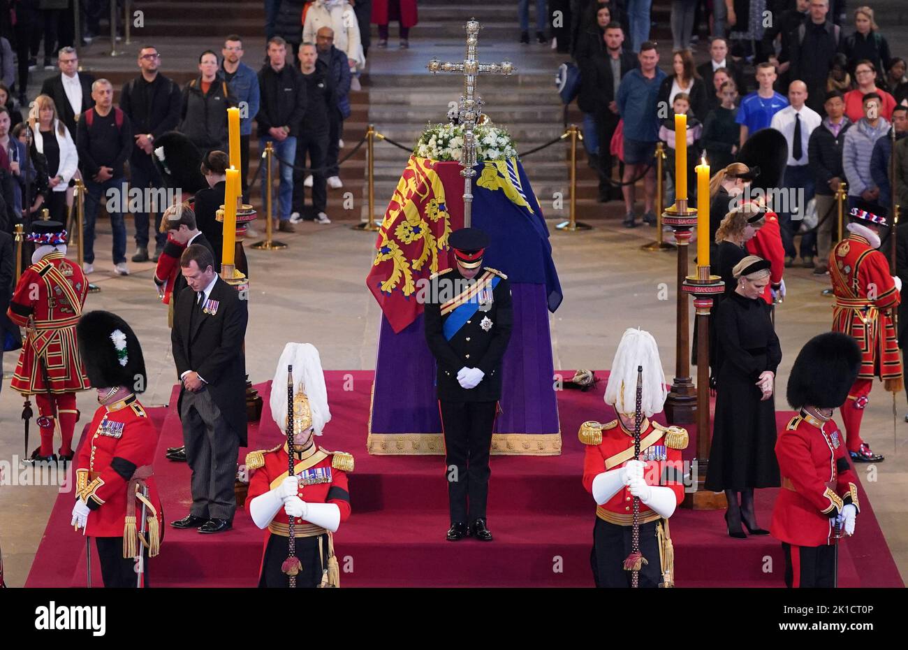 Queen Elizabeth II 's grandchildren (clockwise from front centre) the Prince of Wales, Peter Phillips, James, Viscount Severn, Princess Eugenie, the Duke of Sussex, Princess Beatrice, Lady Louise Windsor and Zara Tindall hold a vigil beside the coffin of their grandmother as it lies in state on the catafalque in Westminster Hall, at the Palace of Westminster, London. Picture date: Saturday September 17, 2022. Stock Photo