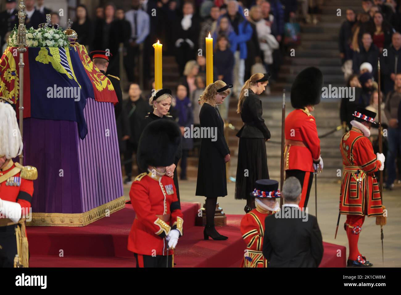 Queen Elizabeth II's grandchildren (left-right) Zara Tindall, Lady Louise Windsor and Princess Beatrice hold a vigil beside the coffin of their grandmother as it lies in state on the catafalque in Westminster Hall, at the Palace of Westminster, London. Picture date: Saturday September 17, 2022. Stock Photo