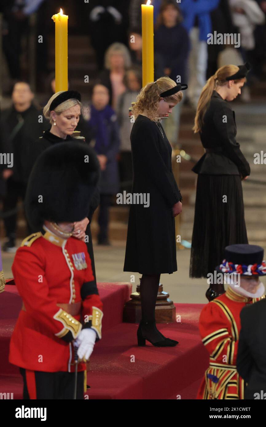 Queen Elizabeth II's grandchildren (left-right) Zara Tindall, Lady Louise Windsor and Princess Beatrice hold a vigil beside the coffin of their grandmother as it lies in state on the catafalque in Westminster Hall, at the Palace of Westminster, London. Picture date: Saturday September 17, 2022. Stock Photo