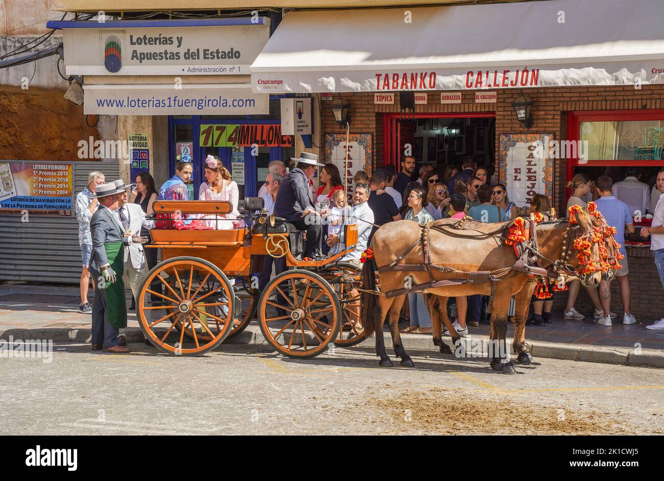 Traditional decorated horse carriage, in front of spanish bar, during