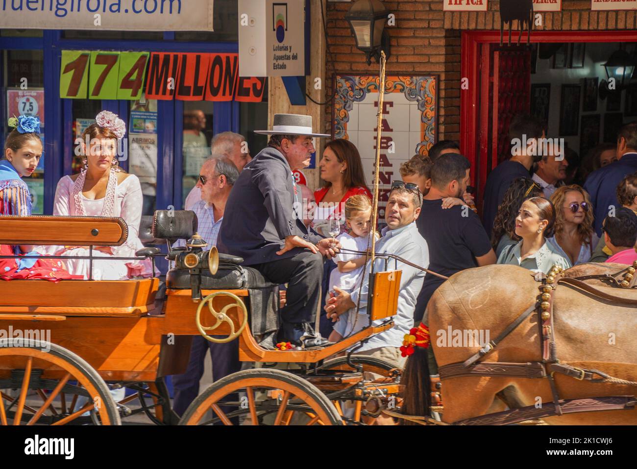 Traditional decorated horse carriage, in front of spanish bar, during