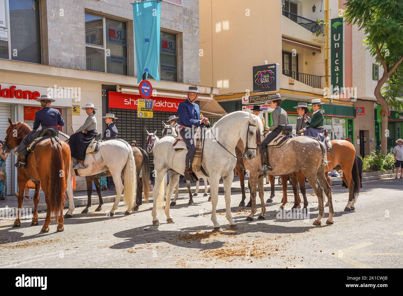 Men and women in traditional spanish costumes horseback riding during annual Horse day. Fuengirola, Andalusia, Costa del Sol, Spain. Stock Photo