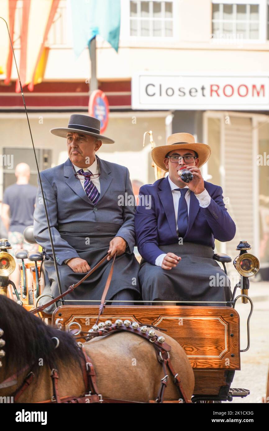 Two coachmen in traditional spanish costume, with a horse carriage, annual Horse day. Fuengirola, Andalusia, Costa del Sol, Spain. Stock Photo