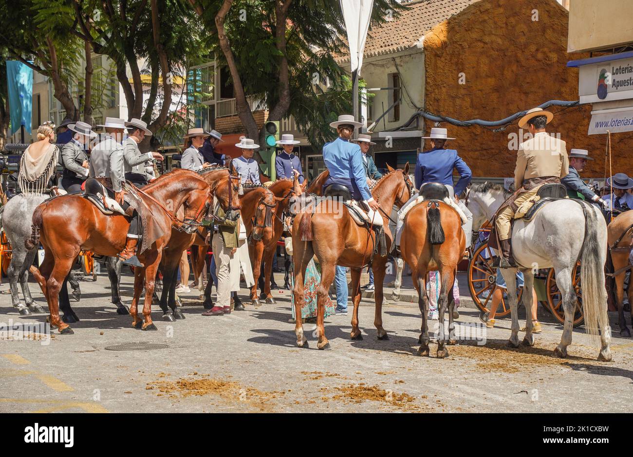 Spanish Riding Hats Men and women in traditional spanish costumes horseback riding during ...