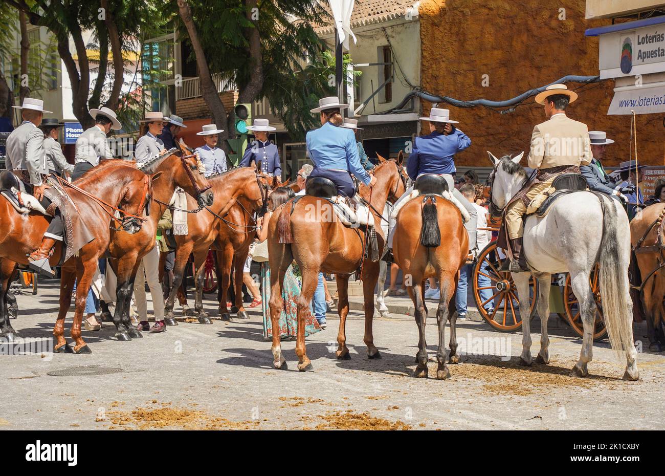 Spanish Riding Hats Men and women in traditional spanish costumes horseback riding during ...