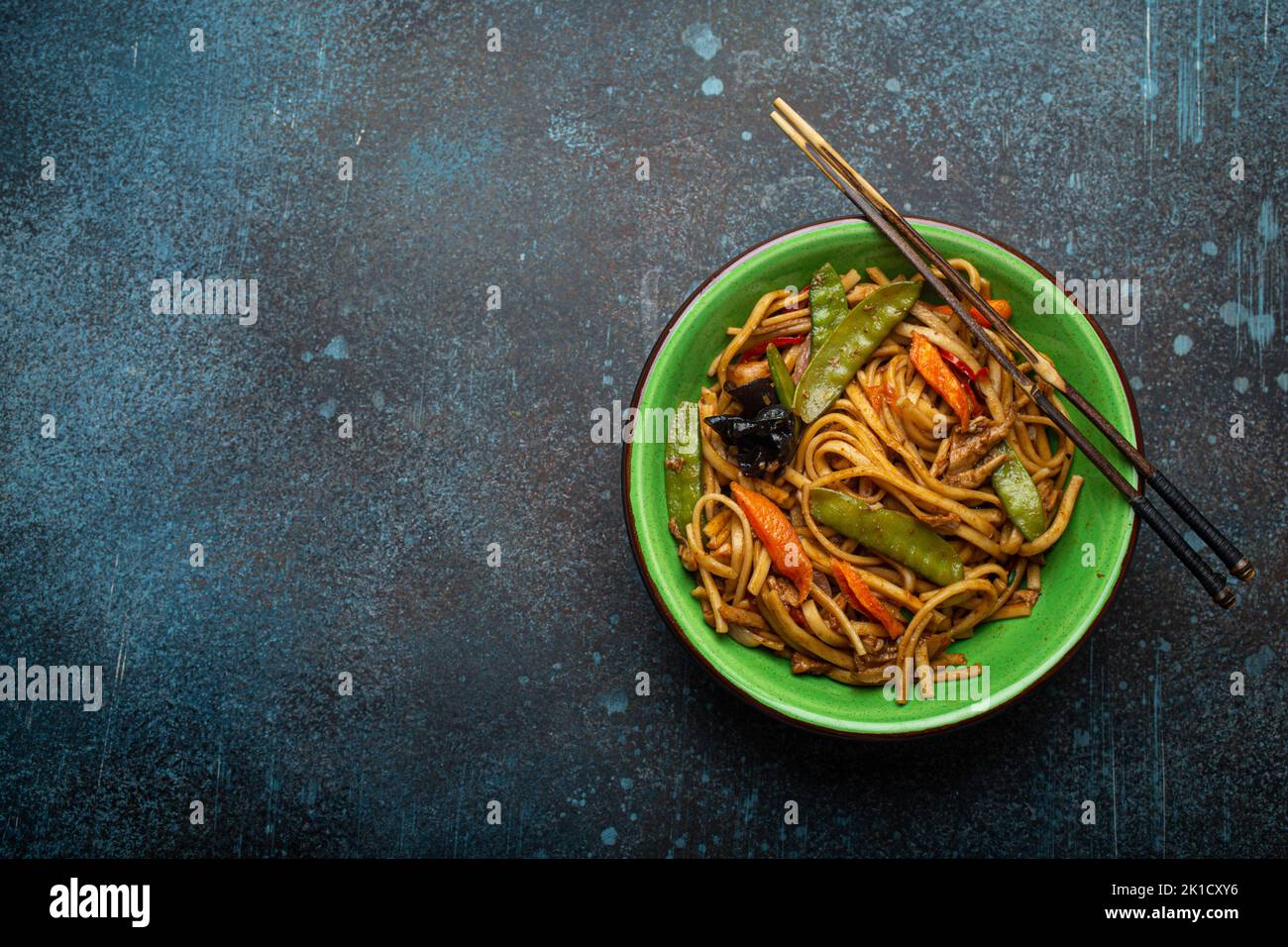 Asian Stir Fry Noodles With Chicken And Veggies In Green Bowl Top View all-recipes-that-oven-feelin