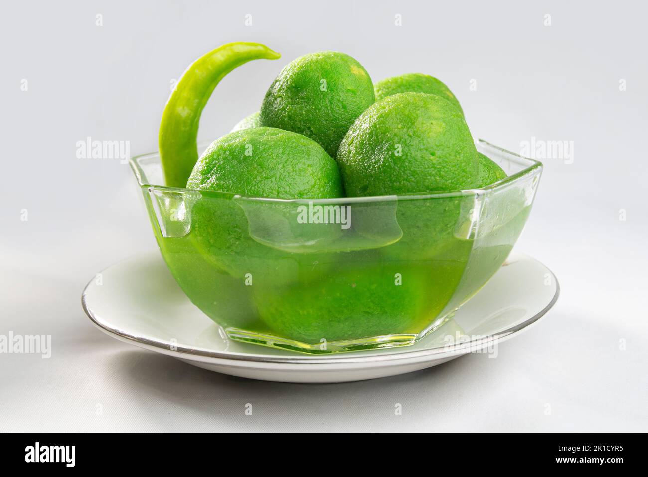 Chili sweets on bowl. green colored, chilli flavored, hot and sweet taste. unusual odd taste. Stock Photo