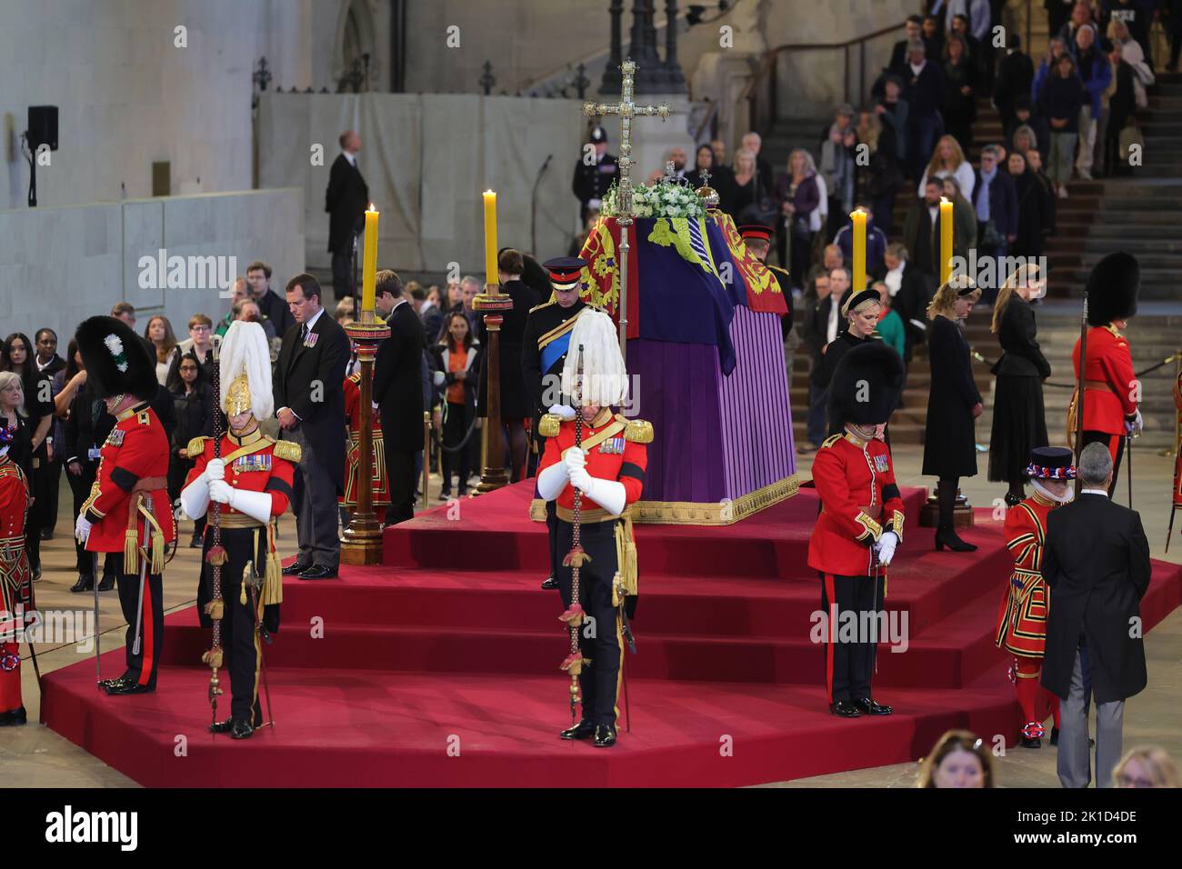 Queen Elizabeth II's grandchildren (clockwise from front centre) the Prince of Wales, Peter Phillips, James, Viscount Severn, Princess Eugenie, the Duke of Sussex, Princess Beatrice, Lady Louise Windsor and Zara Tindall hold a vigil beside the coffin of their grandmother as it lies in state on the catafalque in Westminster Hall, at the Palace of Westminster, London. Picture date: Saturday September 17, 2022. Stock Photo