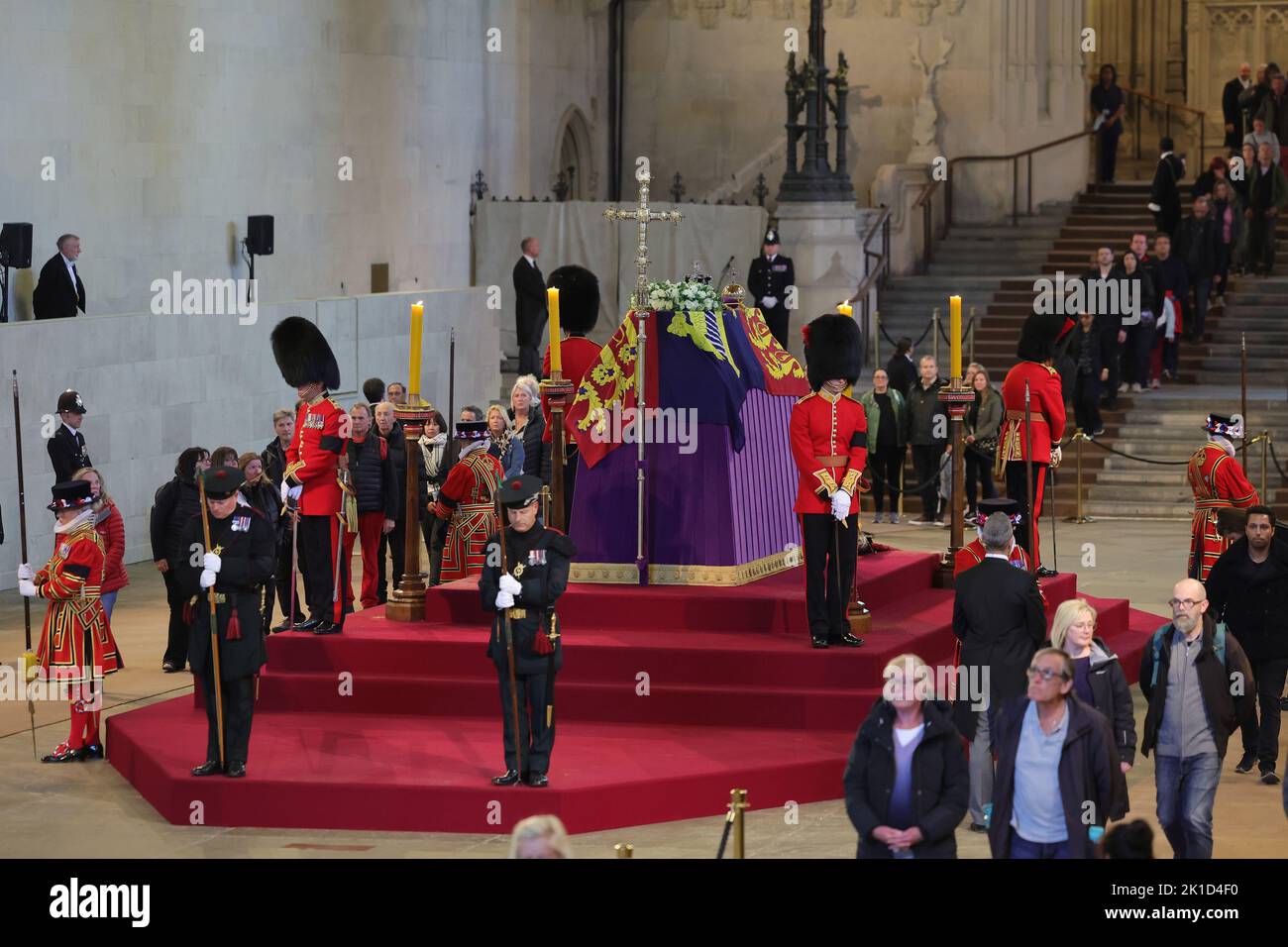 Members of the public file past the coffin of Queen Elizabeth II, draped in the Royal Standard with the Imperial State Crown and the Sovereign's orb and sceptre, lying in state on the catafalque in Westminster Hall, at the Palace of Westminster, London, ahead of her funeral on Monday. Picture date: Saturday September 17, 2022. Stock Photo