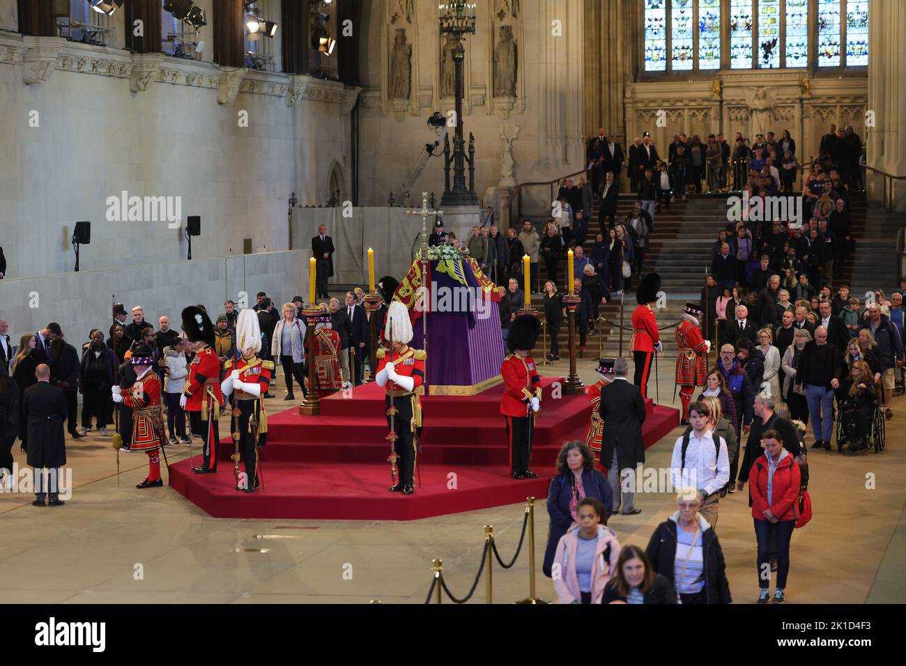 Members of the public file past the coffin of Queen Elizabeth II, draped in the Royal Standard with the Imperial State Crown and the Sovereign's orb and sceptre, lying in state on the catafalque in Westminster Hall, at the Palace of Westminster, London, ahead of her funeral on Monday. Picture date: Saturday September 17, 2022. Stock Photo