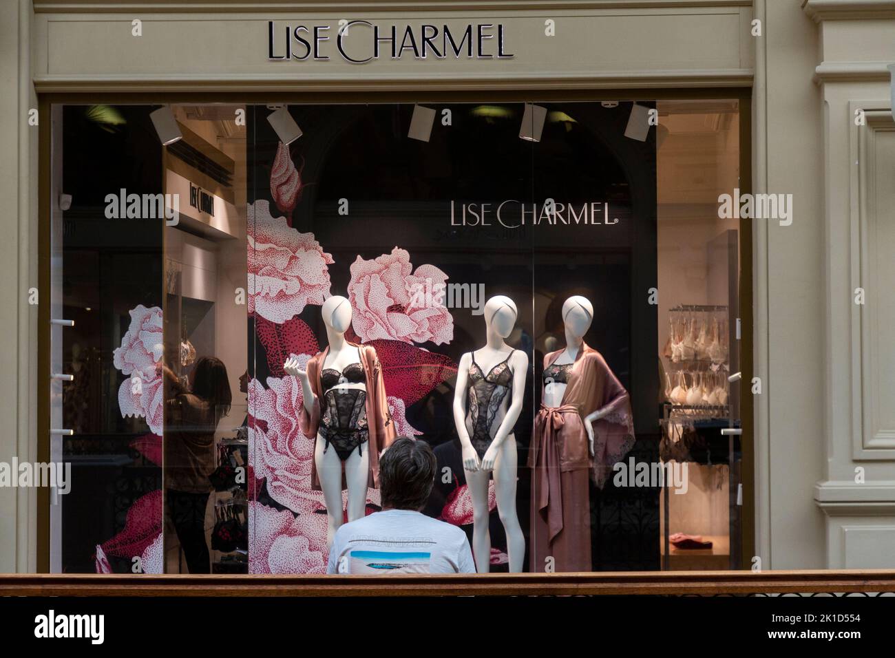 Moscow, Russia. 17th of September, 2022. A man seats in front of the Lise Charmel brand shop in  the GUM central shopping center in Moscow, Russia Stock Photo