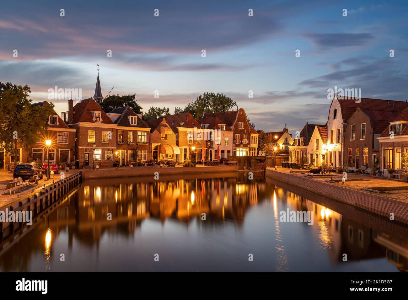 Dutch village of Spaarndam at dusk, view of the historical houses along the sluice Stock Photo