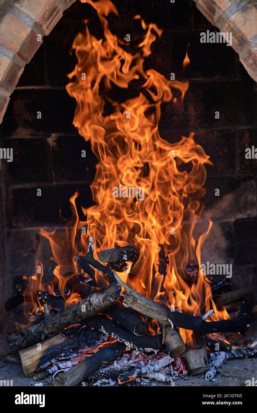 Empty flaming charcoal grill with open fire, ready for product placement. Stock Photo