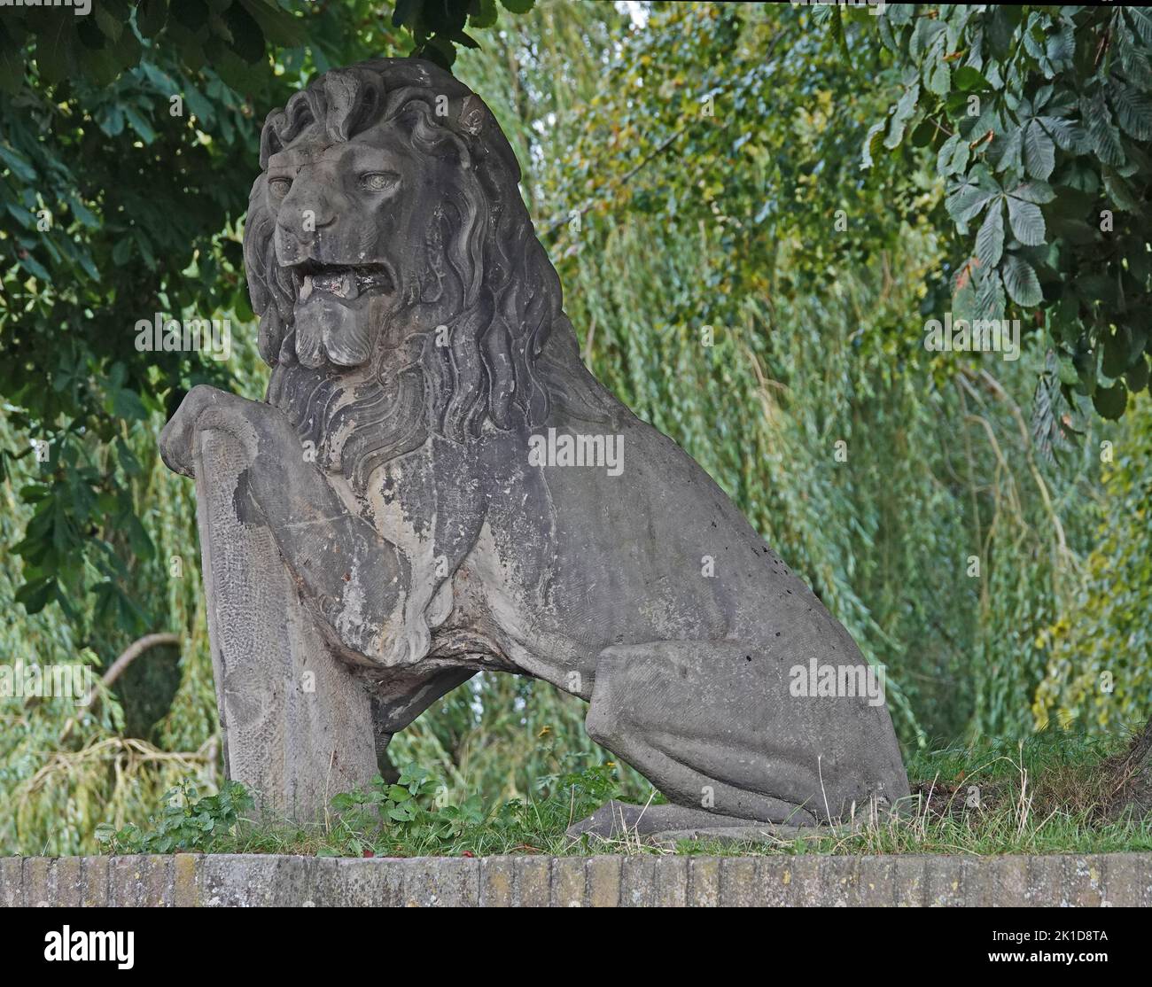 Elburg, the Netherlands - Sept. 9 2022 Stone lion from the 19th century on the fortifications of Elburg. This lion was in the past part of a group of Stock Photo