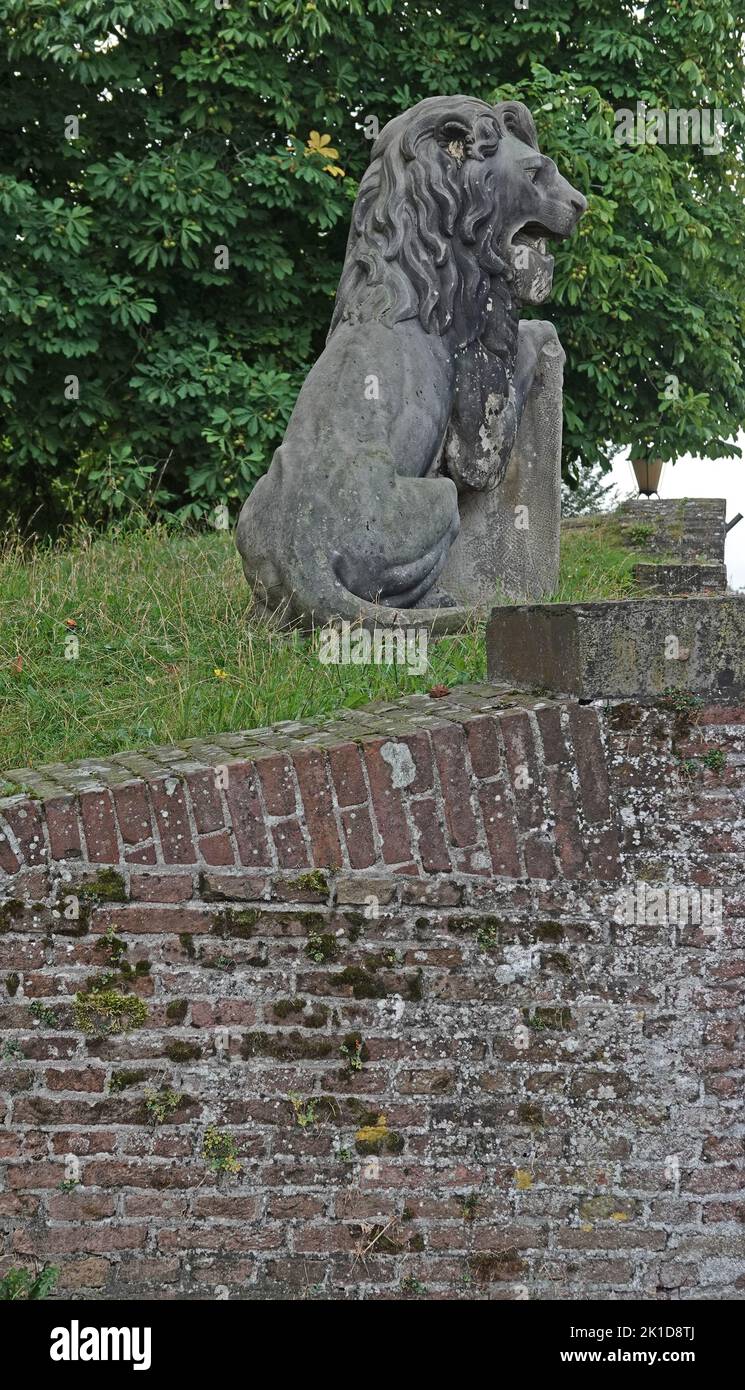 Elburg, the Netherlands - Sept. 9 2022 Stone lion from the 19th century on the fortifications of Elburg. This lion was in the past part of a group of Stock Photo