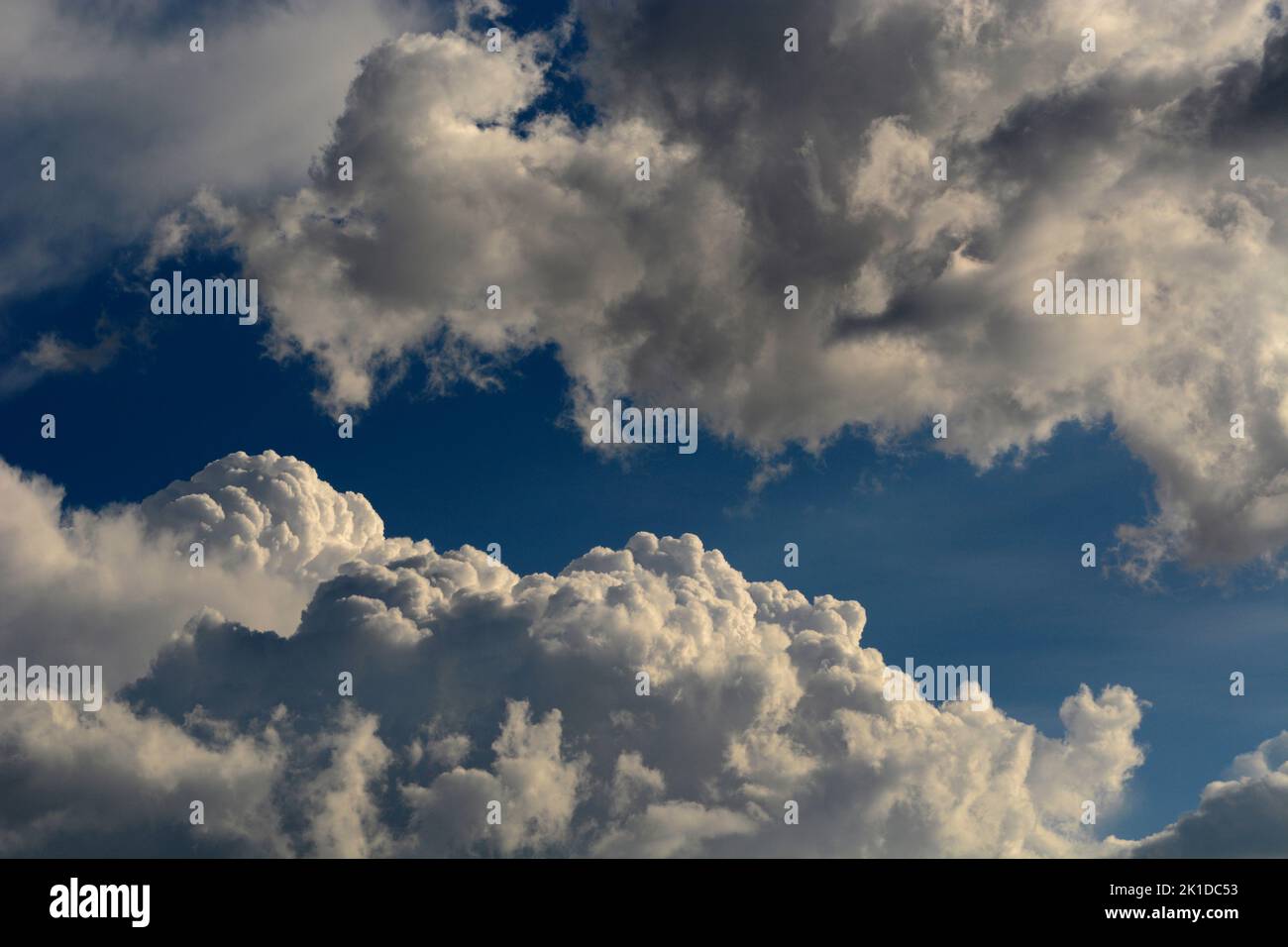 Cumulus clouds fill the sky over the American Southwest near Santa Fe, New Mexico. Stock Photo