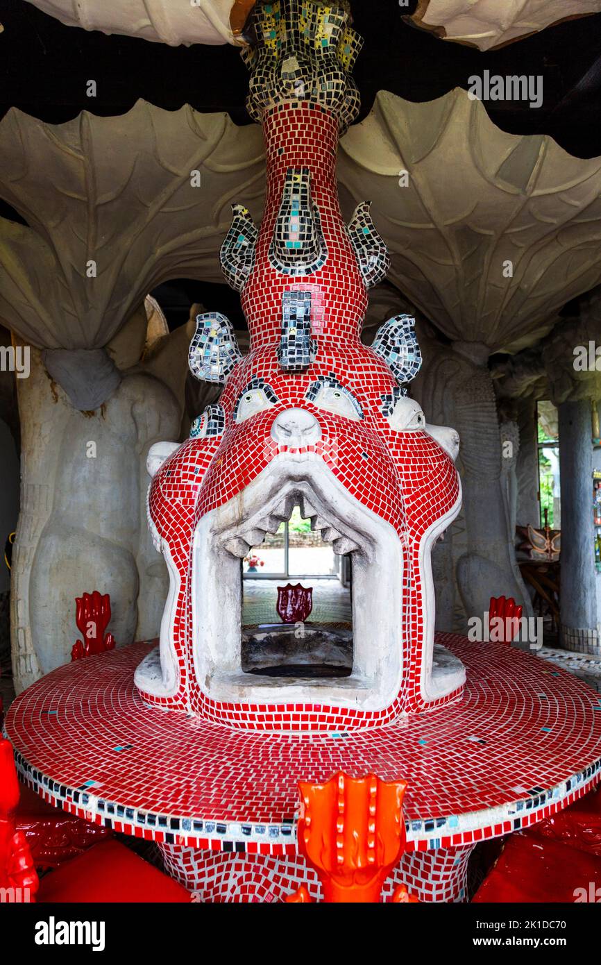 Dining table covered with mosaic with firepit inside the villa at Bruno Weber Park, Dietikon, Switzerland Stock Photo