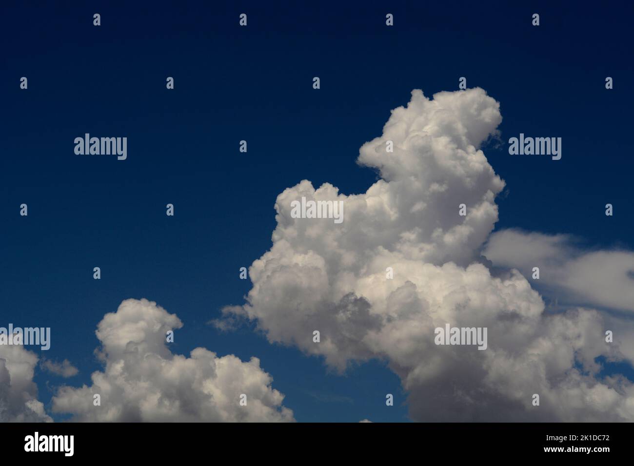 Cumulus clouds fill the sky over the American Southwest near Santa Fe ...