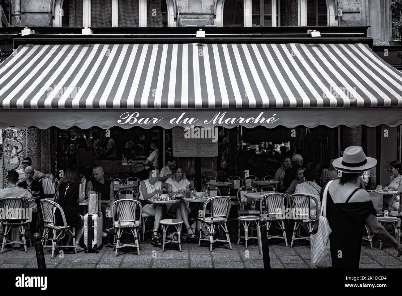 The grayscale view of a cafe on the sidewalkTranslate: The bar Marche Stock Photo