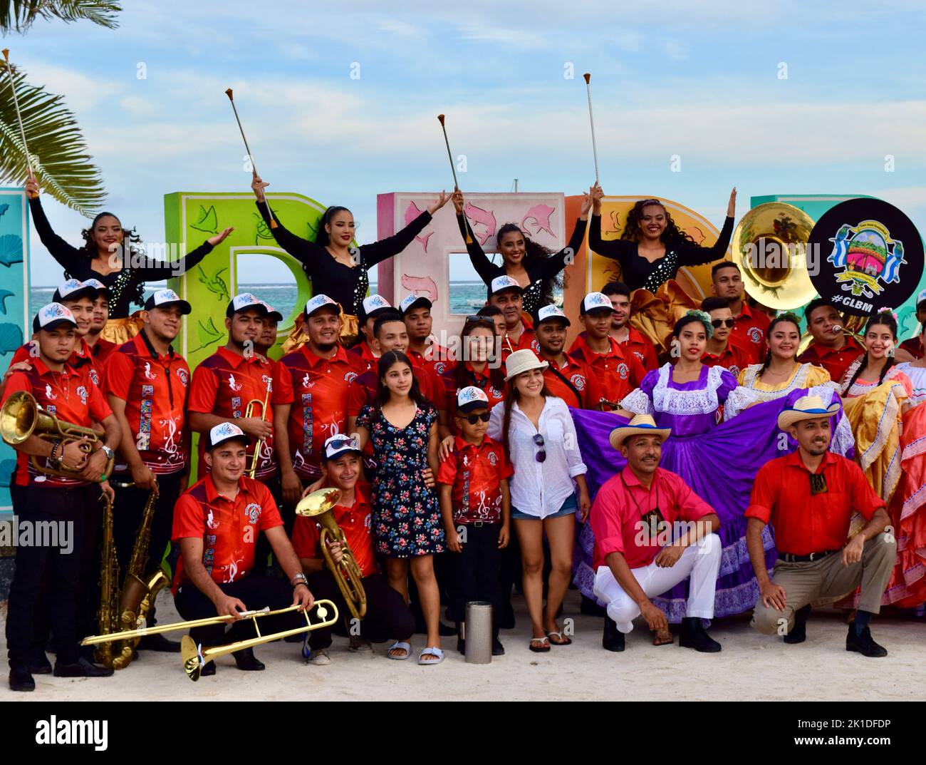 The Guayabal Latin Band Municipal posing in front of the San Pedro sign in Belize before performing for the Noche Centroamericana. Stock Photo