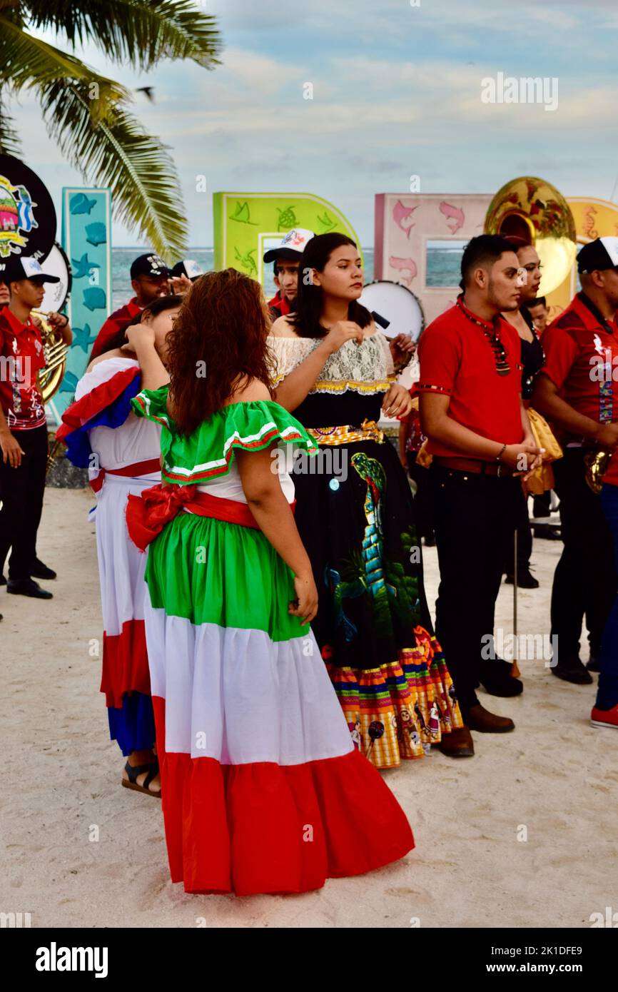 3 ladies in traditional Latin American dresses, representing from left, Mexico, Belize, and