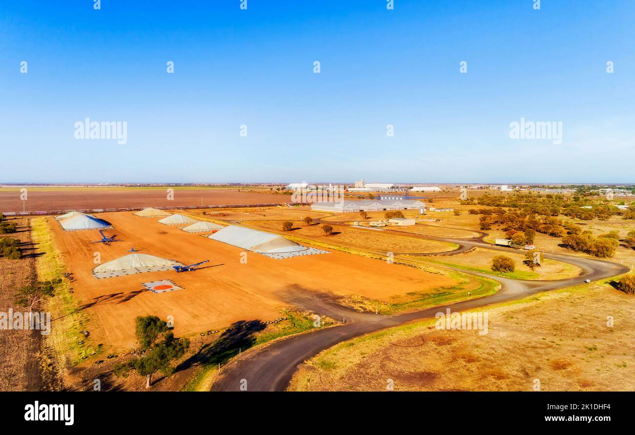 Agriculture industry and grain storage elevator piles in rural regional Moree town of Australia - aerial landscape. Stock Photo
