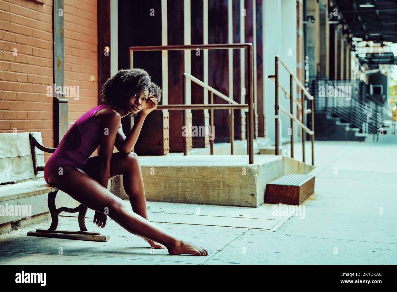 ballerina modern dancer outdoors sitting on a bench Stock Photo