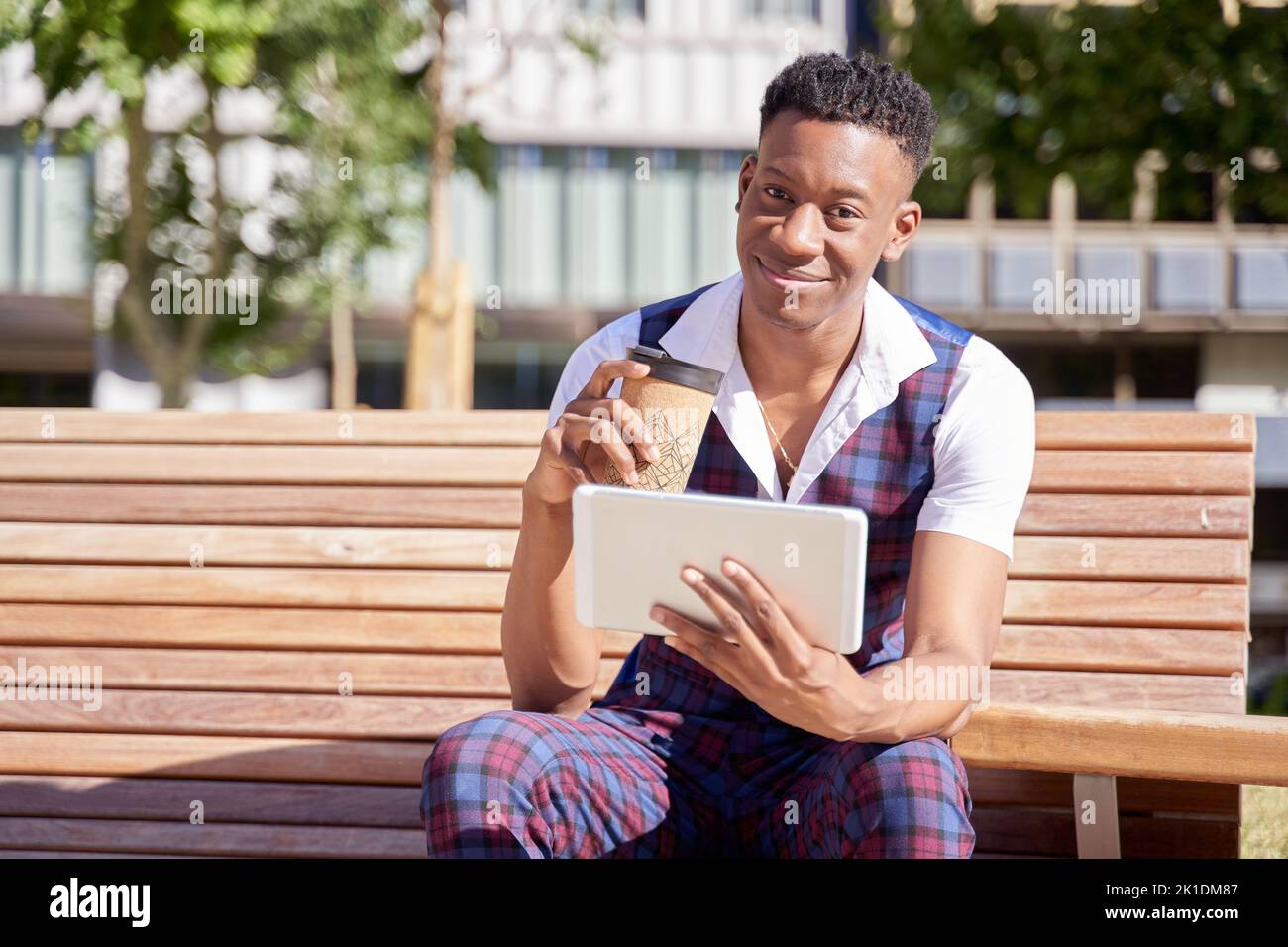 african american young man with tablet computer and take away coffee Stock Photo